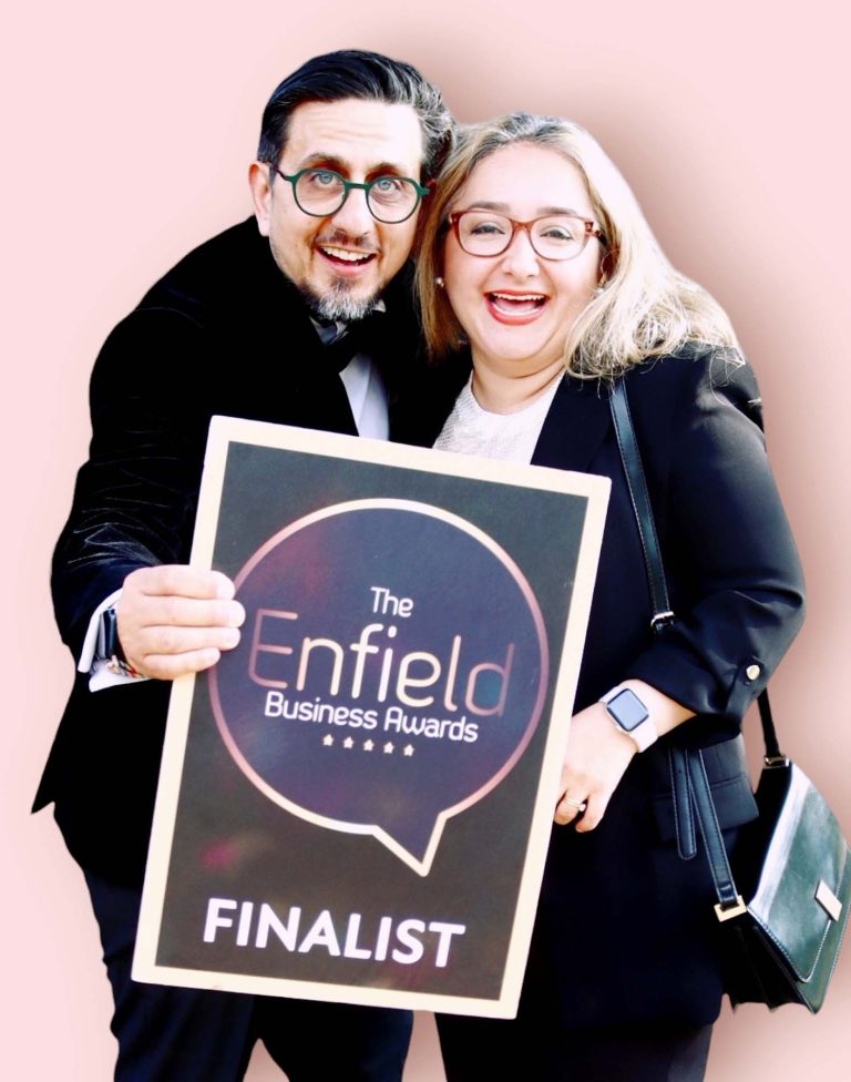 Garry Kousoulou holding an Enfield Business Awards finalist sign
